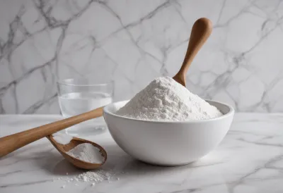 A scoop of beta-alanine powder next to a shaker on a gym countertop